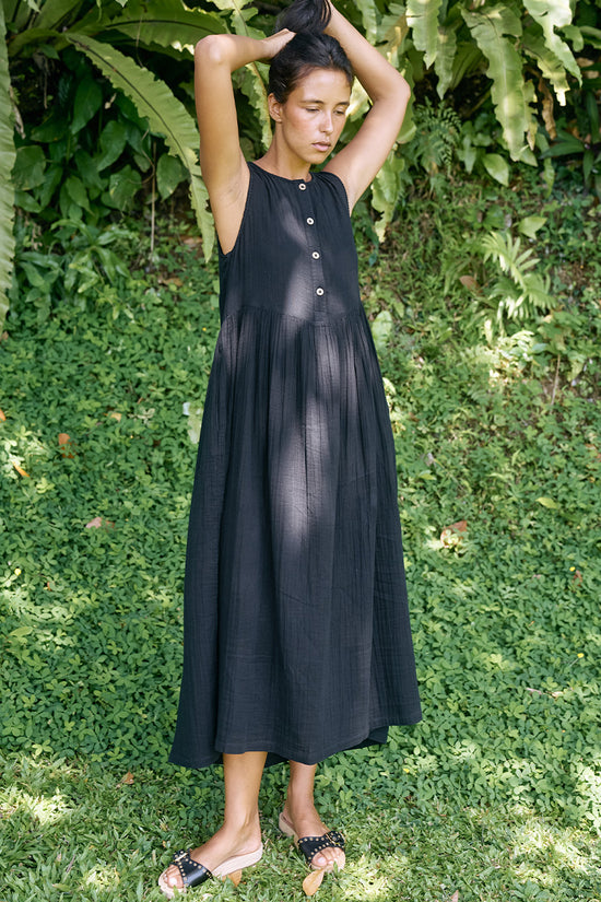 Nadi Dress Black — bodice close-up showing wooden button front detail, black double gauze cotton fabric texture with gathered waist | Daughters of India