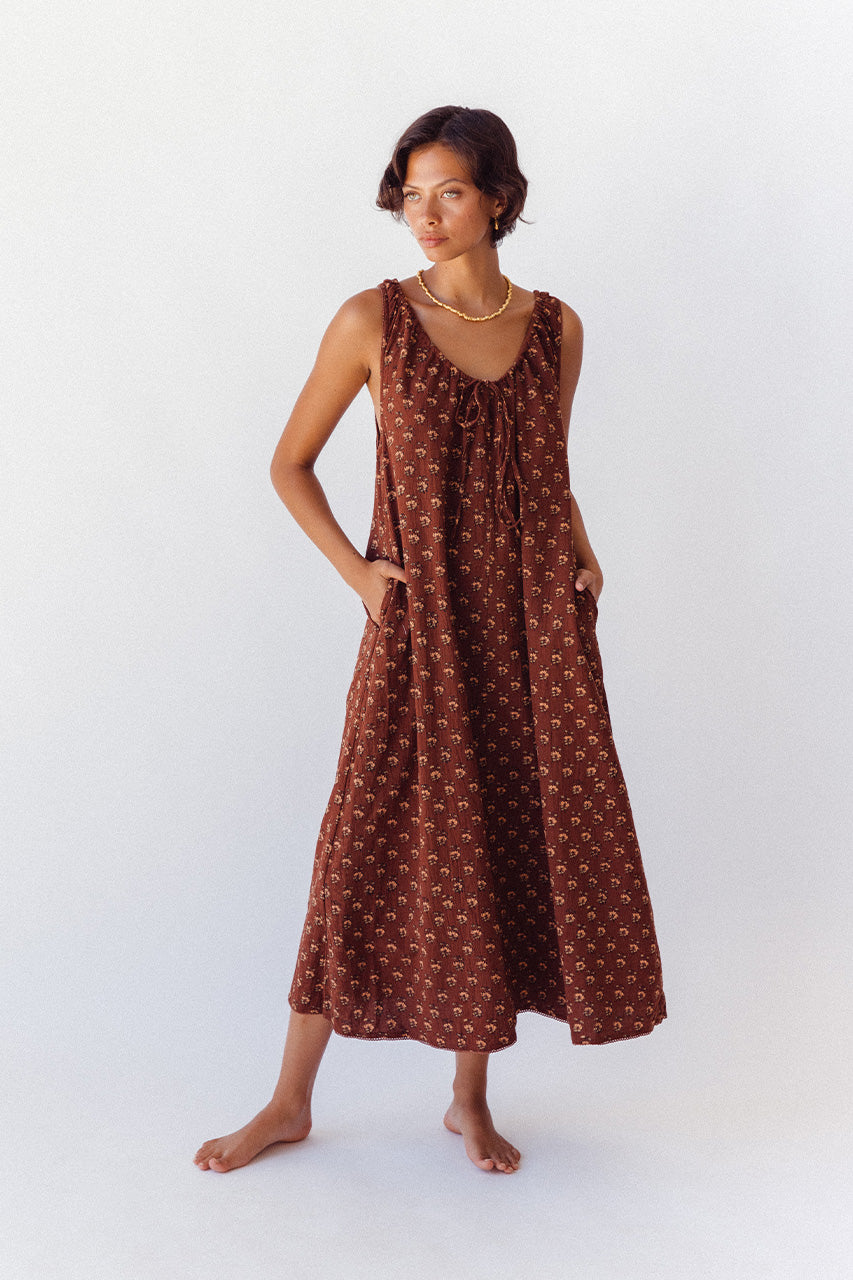 Sundress Midi Almond — model walking in garden courtyard, full length movement shot, flowing midi length skirt, almond cotton hand block print dress, ethical Indian fashion | Daughters of India